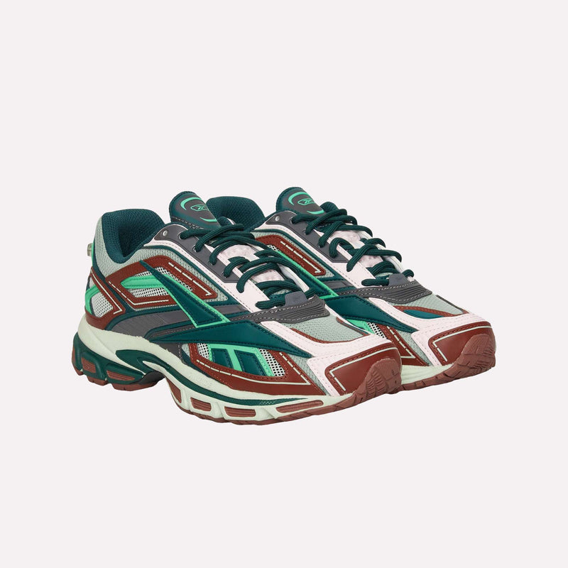 The Reebok Premier Road Ultra LTD Shoes, inspired by archival running silhouettes, feature a chunky sole and a layered design with teal, maroon, white, and green accents. They are displayed on a light background.