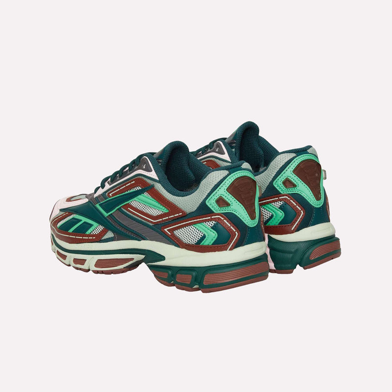 The Reebok Premier Road Ultra LTD Shoes are shown from the back angle on a plain light background, featuring an archival running silhouette in green, mint, brown, and white with mesh and leather details.