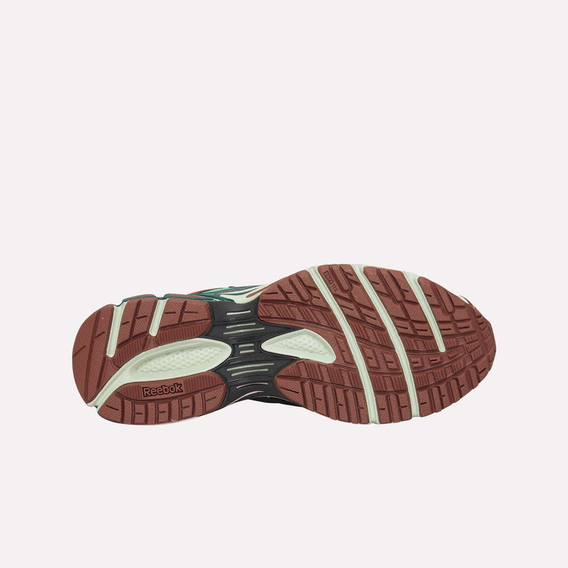 The image displays the brown and cream-colored sole of the Reebok Premier Road Ultra LTD Shoes, highlighting its textured tread patterns for enhanced traction and flexibility, as well as a dual-density midsole—all set against a plain white background.