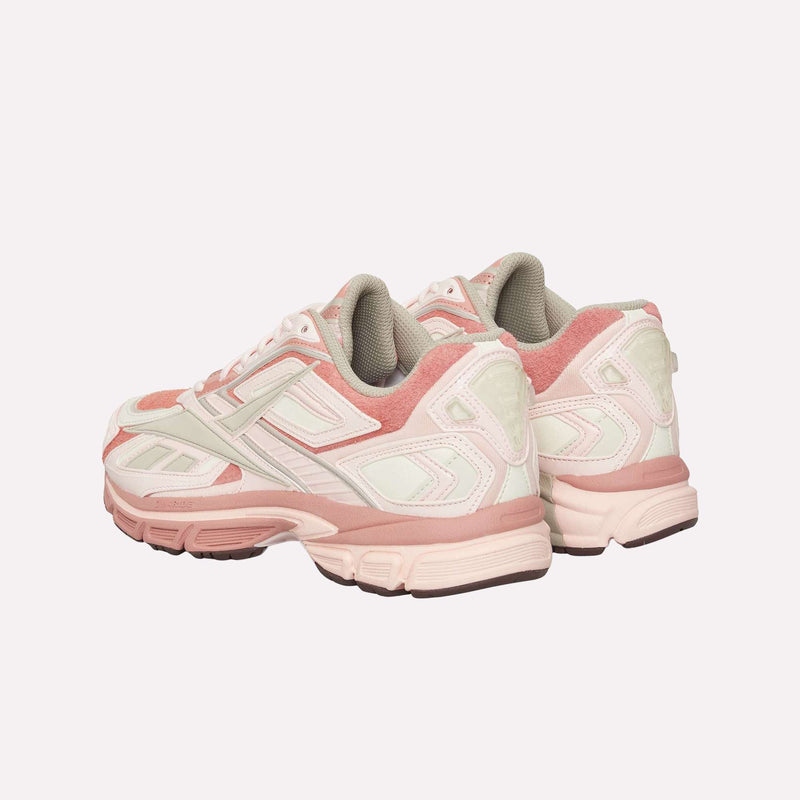 A pair of Reebok Premier Road Ultra LTD Shoes in pink and white with gray accents, featuring a dual-density midsole, is shown from the back and slightly to the side against a plain light background.