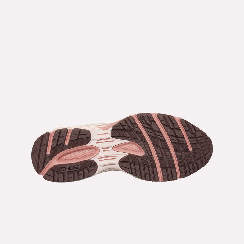 The image displays the sole of the Reebok Premier Road Ultra LTD Shoes, highlighting a pink and brown tread pattern with textured grip sections and the Reebok logo near the heel. Designed as an archival running sneaker, this model also features a dual-density midsole for enhanced comfort and support.