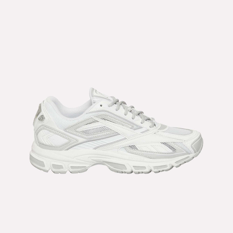 The Reebok Premier Road Ultra LTD Shoes are displayed in side profile against a plain light background, featuring a white athletic design with gray accents, mesh panels, and a textured rubber sole that highlights their archival running silhouette inspired by the original Reebok Premier Road Ultra. The shoes also offer enhanced comfort with a supportive dual-density midsole.