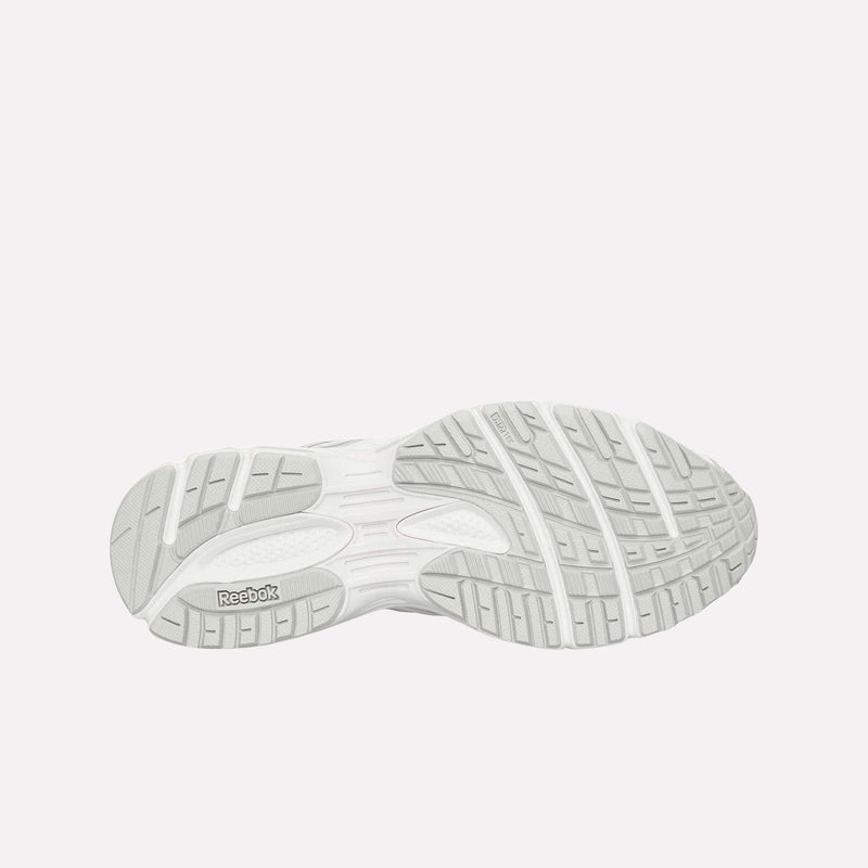 Bottom view of a white Reebok Premier Road Ultra LTD Shoe, featuring a detailed tread pattern and the Reebok logo on the sole, set against a plain light background. The image also showcases the advanced dual-density midsole engineered for superior comfort and support.