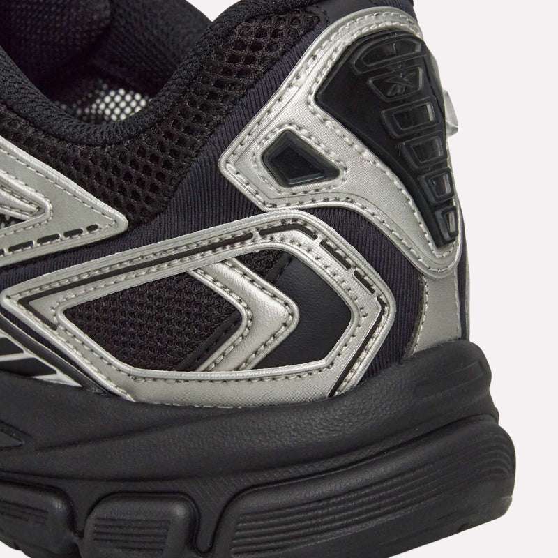 Close-up of the heel area of the Reebok Premier Road Ultra Shoes, a black and silver running sneaker featuring textured mesh fabric, metallic accents, detailed stitching, and a dual-density midsole designed for enhanced comfort.