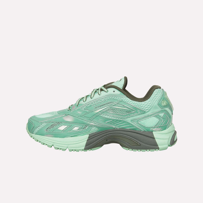 The Reebok Premier Road Ultra Shoes, featuring a mint green athletic design with dark green accents, mesh details, and a textured sole that highlights the brand’s archival running silhouette, are displayed in side profile against a plain white background.