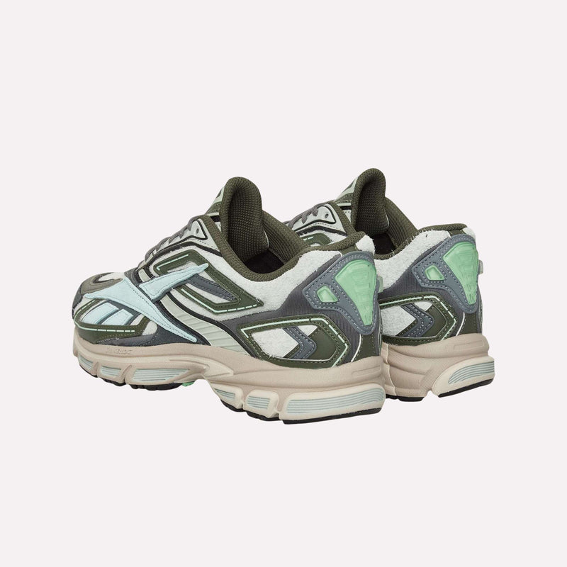 A pair of Reebok Premier Road Ultra Shoes—chunky, multicolored sneakers inspired by archival running styles and accented in green, white, gray, and mint—are angled from the back against a plain light background. Engineered with a dual-density midsole for enhanced comfort and stability, these shoes combine Reebok heritage design with modern performance features.