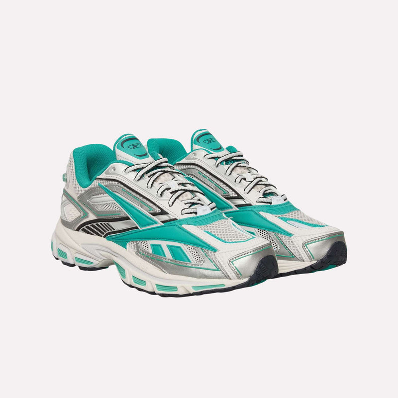 A pair of Reebok Premier Road Ultra Shoes in white mesh with teal and black accents, teal lining, and black-and-white laces are arranged side by side on a plain light background. These running shoes feature a dual-density midsole for enhanced comfort.