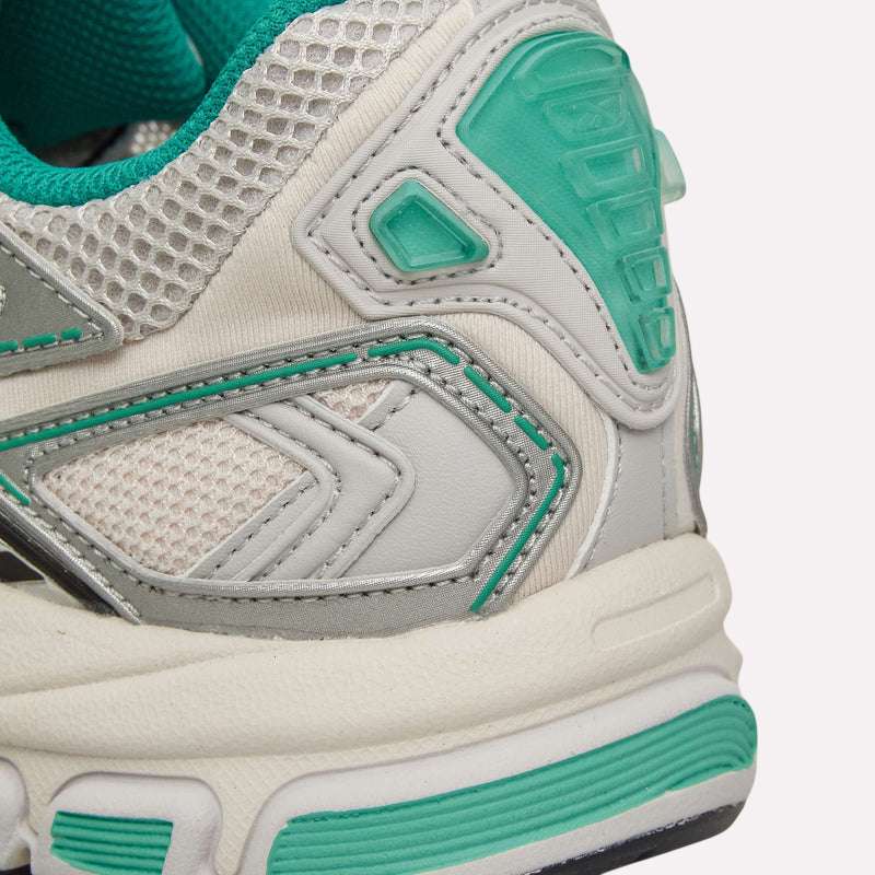 Close-up of the heel and side of the Reebok Premier Road Ultra Shoes, a white archival running sneaker featuring teal and silver accents, mesh and leather details, and a thick dual-density midsole for enhanced cushioning.