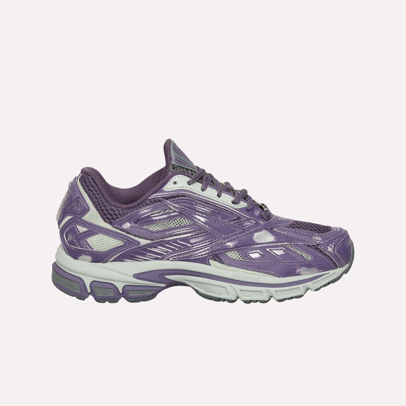 A side view of the Reebok Premier Road Ultra Shoes in purple and white, showcasing mesh and synthetic accents along with a dual-density midsole, set against a plain light background.