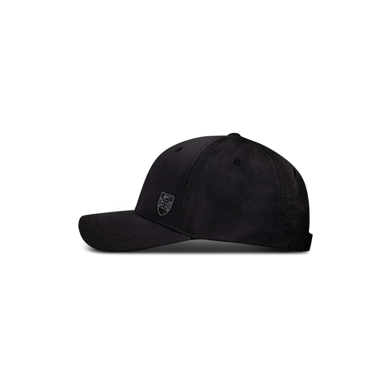 The Reebok Chip Pro is a black baseball cap featuring a curved brim and a subtle embroidered shield logo on the front left, displayed in side profile against a white background.