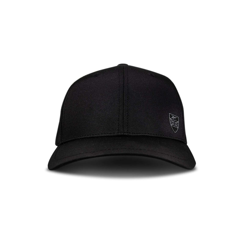 The Reebok Chip Pro is a plain black baseball cap seen from the front, featuring a small, subtle shield-shaped logo on the left side.