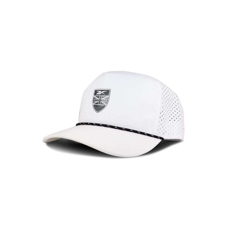 The Reebok Madison is a white baseball cap with a black and white badge on the front, perforated side panels, and a black dotted line across the brim, shown against a white background.