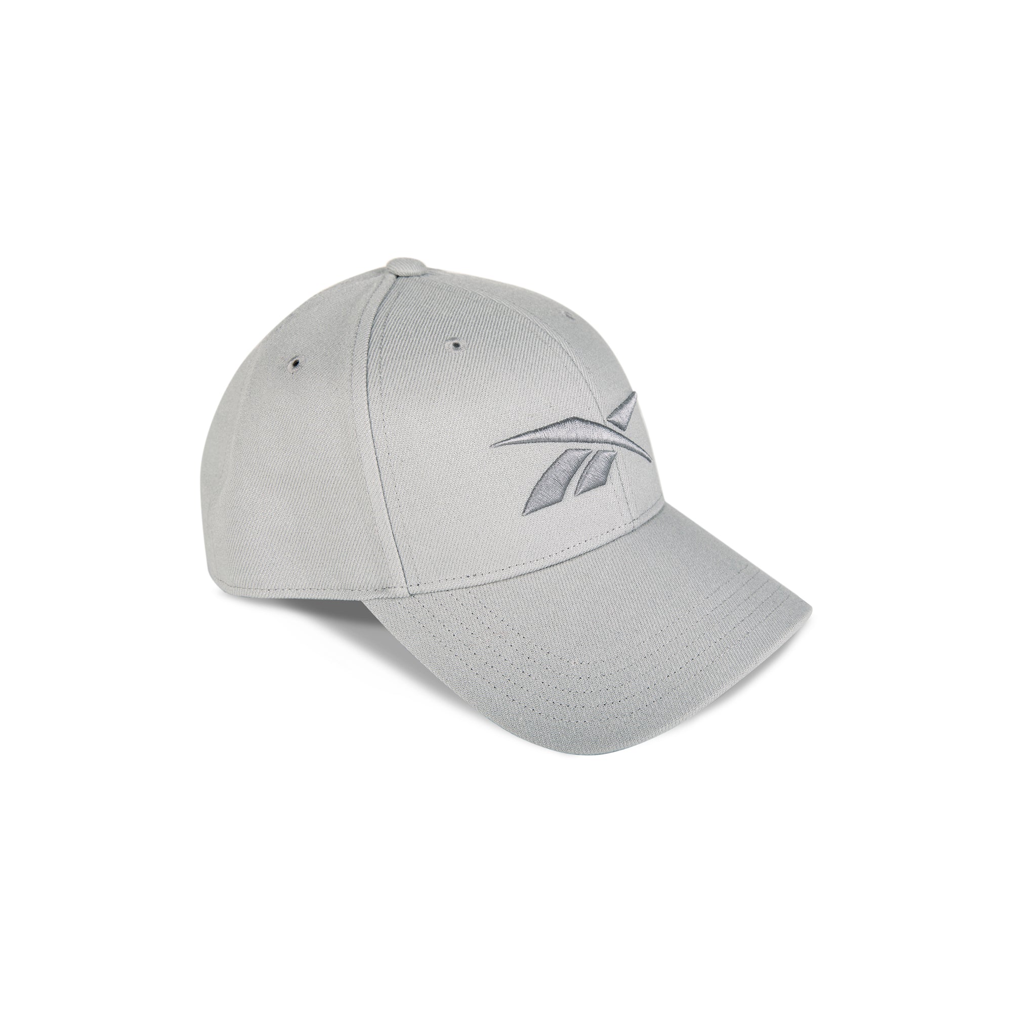 The Reebok Vector Baseball Cap is light gray with a curved brim, embroidered front-left logo, and adjustable snapback closure for comfort, shown on a white background.