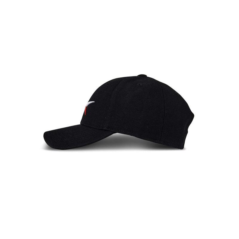 The Reebok Vector Baseball Cap is shown from the side, featuring a black design with a curved brim and a small white and red embroidered logo on the front panel. The background is plain white.