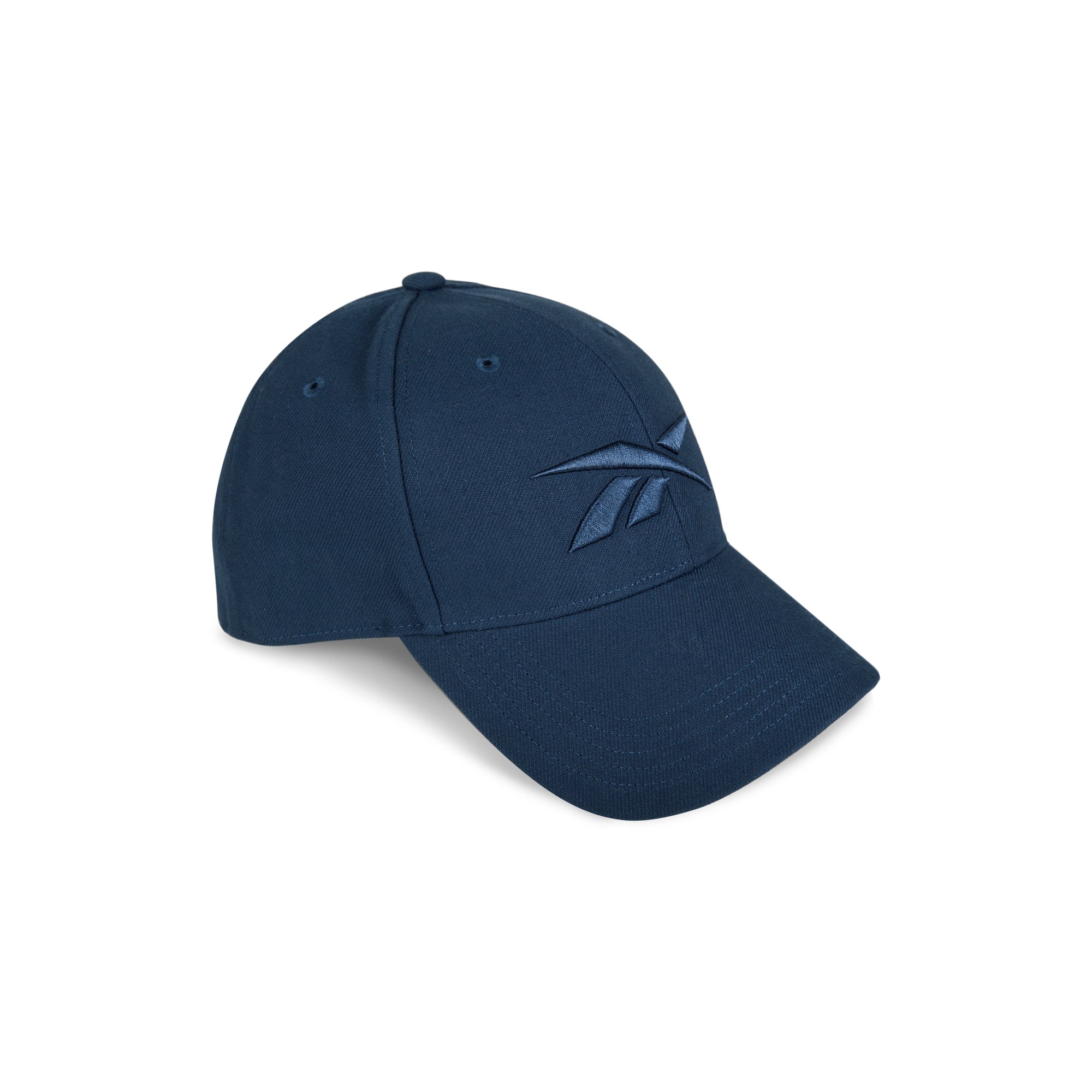 The Reebok Vector Baseball Cap in navy blue features a curved brim, front embroidered logo, and adjustable snapback closure, shown on a white background.