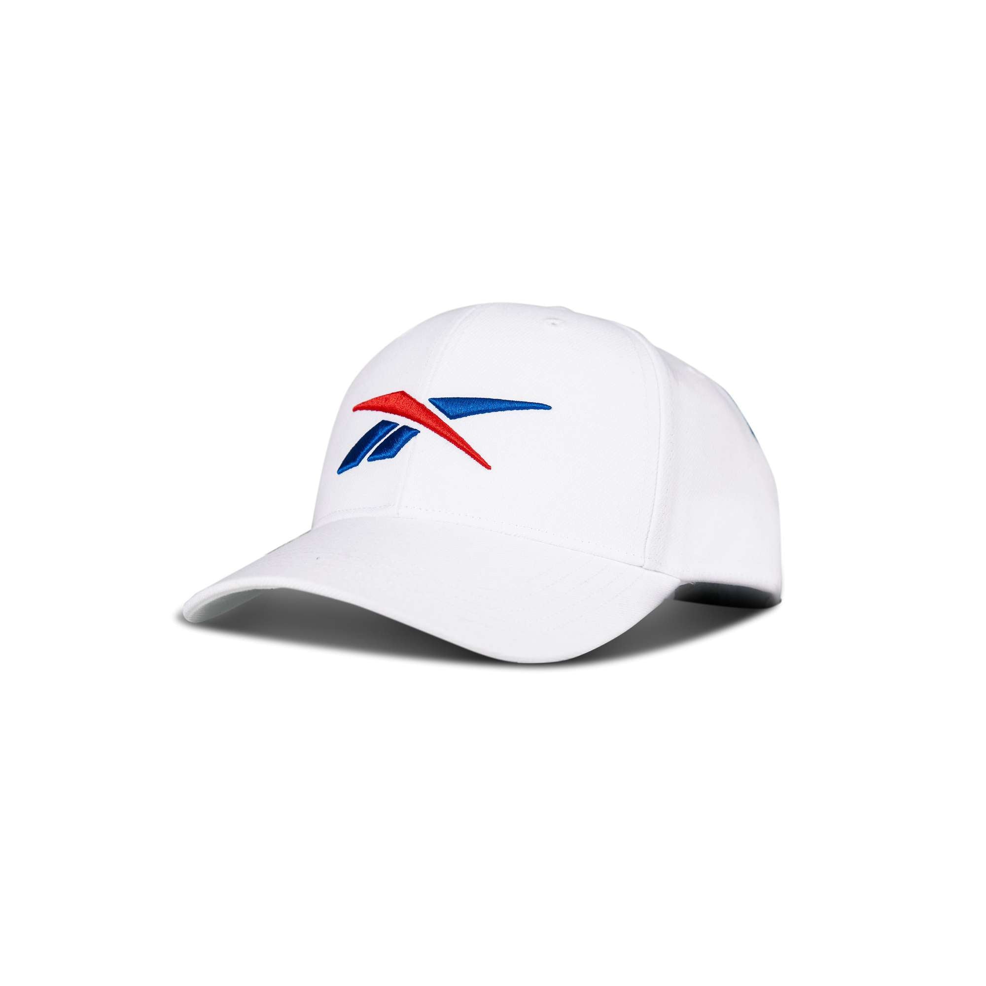 The Reebok Vector Baseball Cap is a white hat with the blue and red Reebok logo on the front, shown against a plain white background.