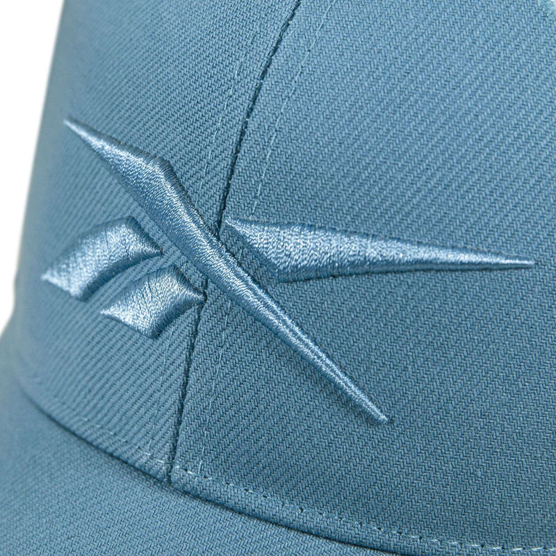 Close-up of the Reebok Vector Baseball Cap in blue, featuring a matching embroidered logo on the front and an adjustable snapback closure for a personalized fit.