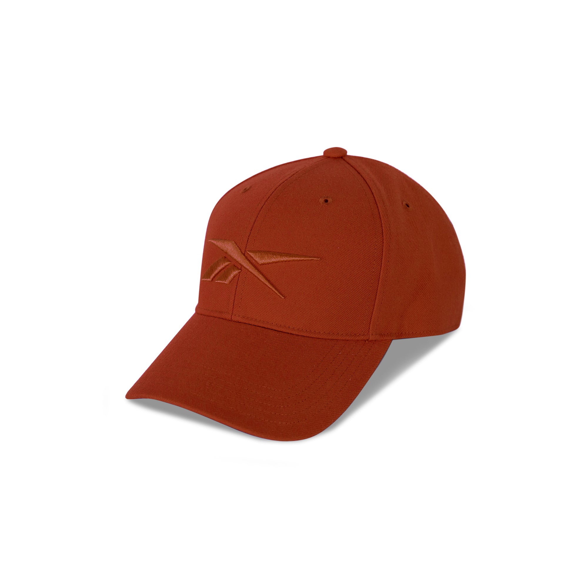 A rust-colored Reebok Vector Baseball Cap with a curved brim and embroidered logo rests on a white background, featuring an adjustable snapback closure for comfort.