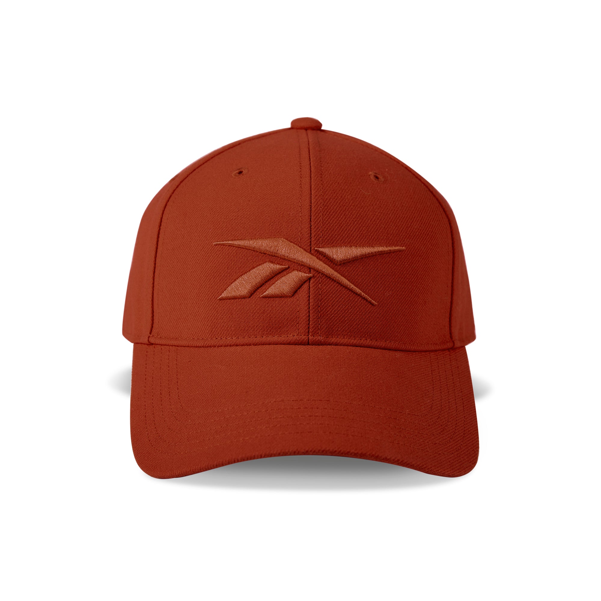 The Vector Baseball Cap by Reebok features a rust-red design, curved brim, adjustable snapback closure, and a matching rust-red embroidered Reebok logo on the front.
