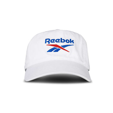 The Reebok Logo Cap is a white baseball cap featuring the brand's logo embroidered in blue and red on the front, shown against a plain white background.