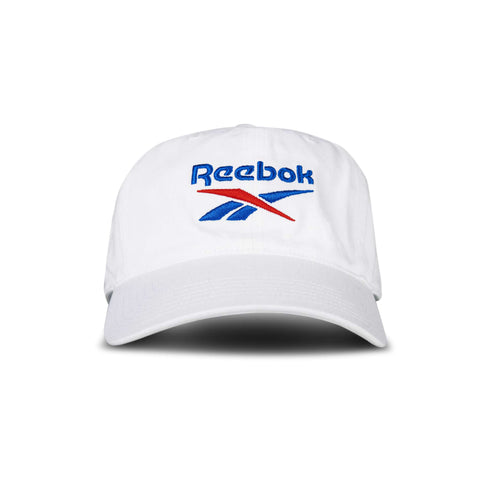 The Reebok Logo Cap is a white baseball cap featuring the brand's logo embroidered in blue and red on the front, shown against a plain white background.