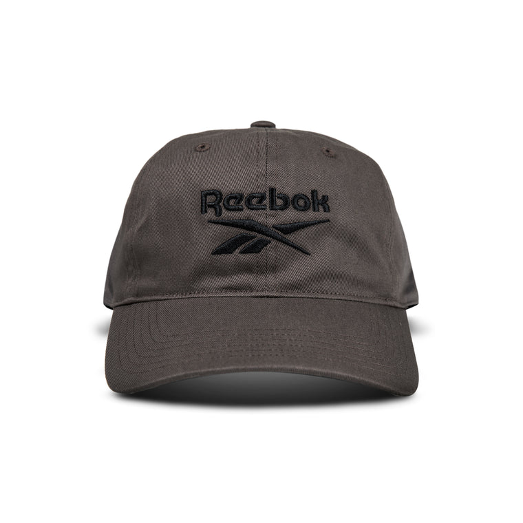 A dark gray Reebok Logo Cap with a black embroidered logo and text on the front is displayed from the front against a white background.