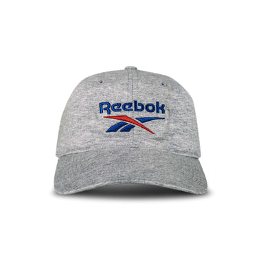 The Reebok Jersey Logo Cap is a light gray baseball cap with a curved brim and an embroidered blue and red Reebok logo on the front, shown against a white background.