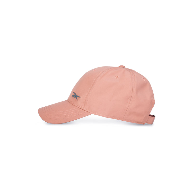 A side view of the Reebok Badge Cap in light pink with a small dark blue front logo, adjustable buckle, shown against a white background.