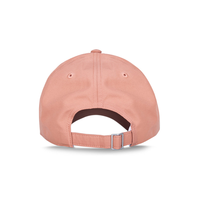 A pink Reebok Badge Cap seen from the back, showing a moisture-wicking design, adjustable buckle with metal hardware, and a small opening above the strap. The background is plain white.