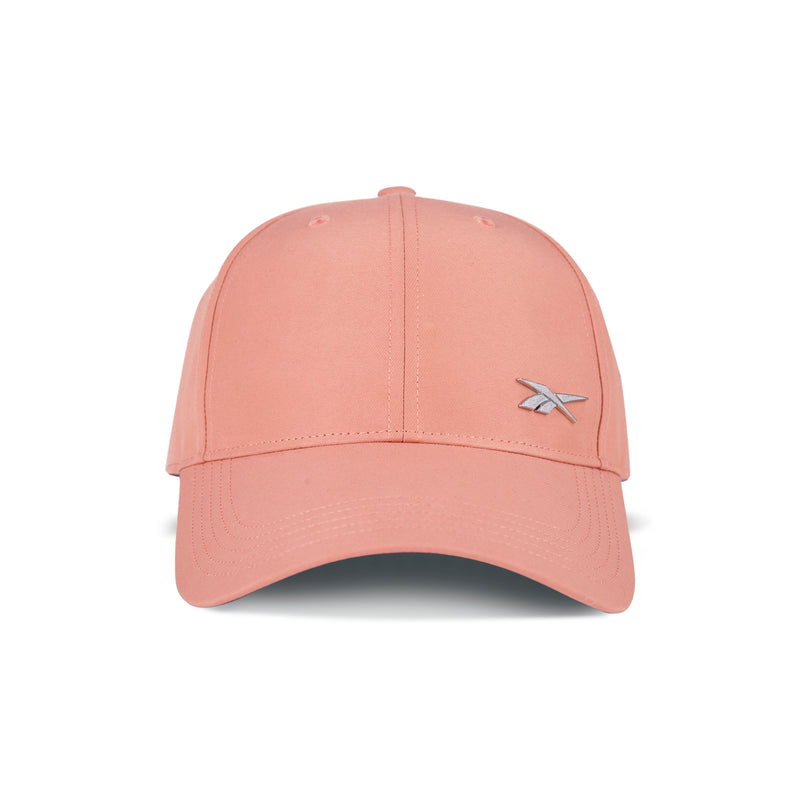 The Reebok Badge Cap is pink with a curved brim, moisture-wicking fabric, a small silver logo on the front left, and an adjustable buckle for a perfect fit—all shown on a white background.