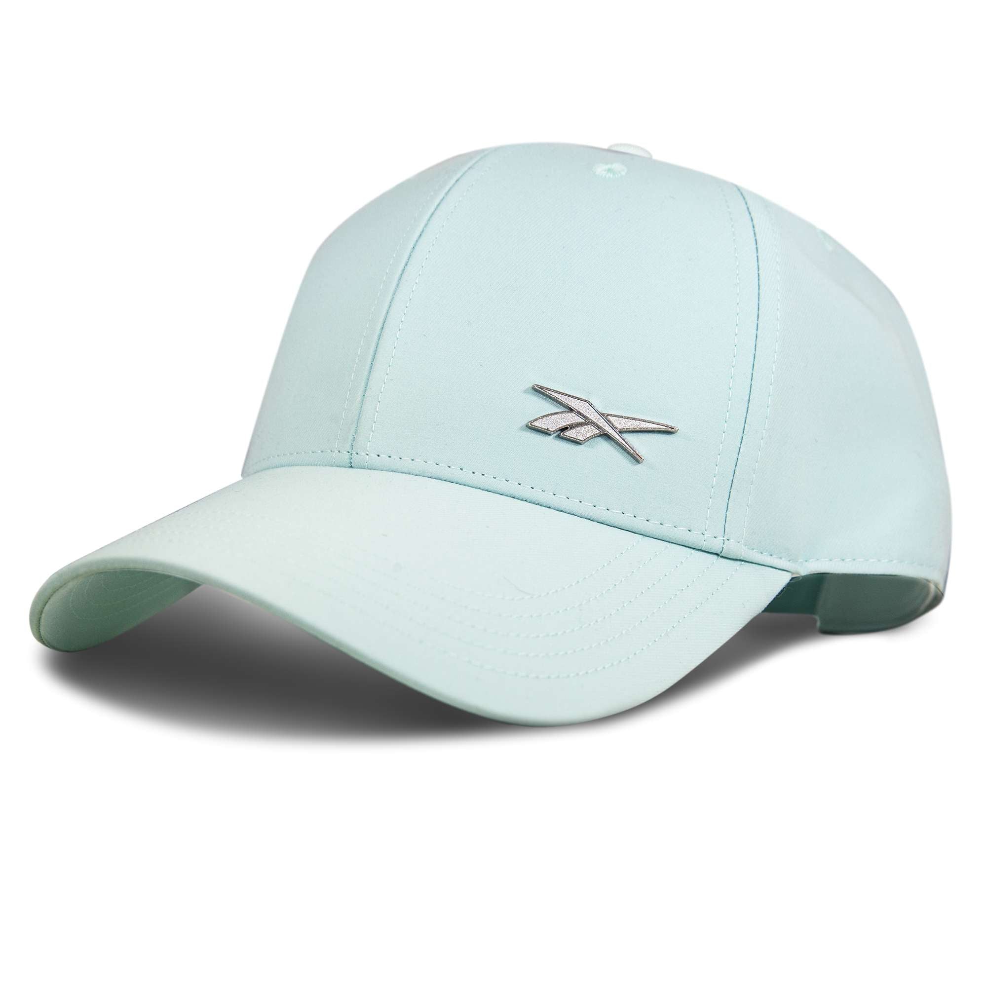 The Reebok Badge Cap in light blue features a curved brim, silver front logo, and a Speedwick sweatband for moisture-wicking comfort. Shown at an angle against a white background.
