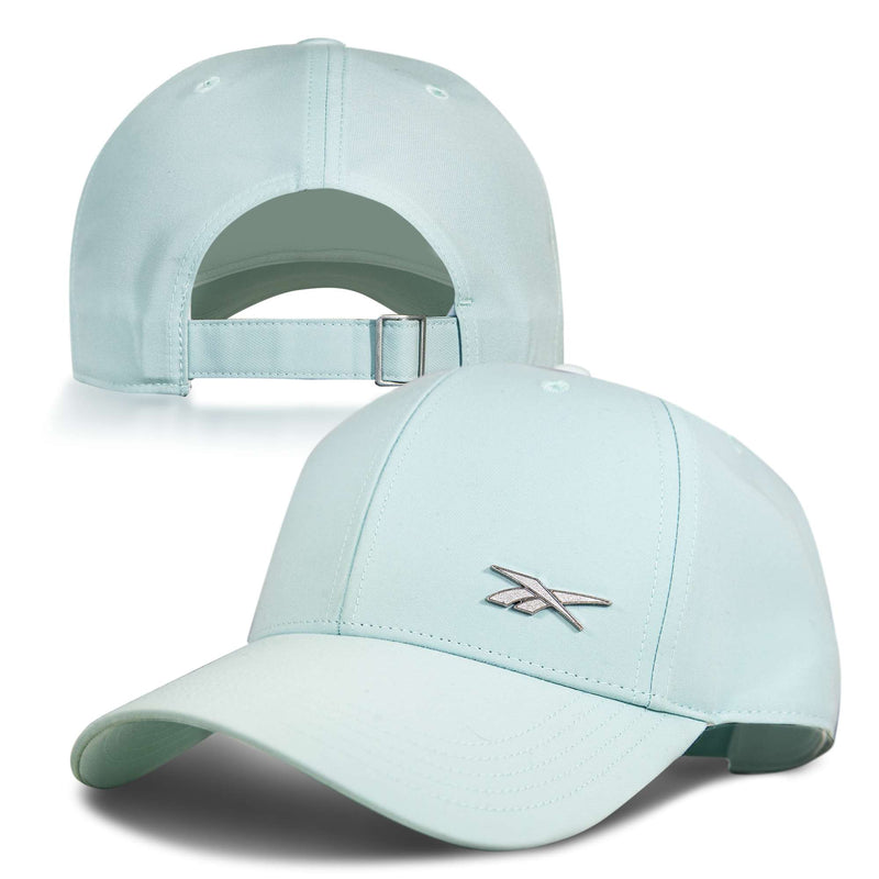 The Reebok Badge Cap in light blue features a silver embroidered logo on the front and an adjustable metal buckle at the back, shown from both angles for a full view.