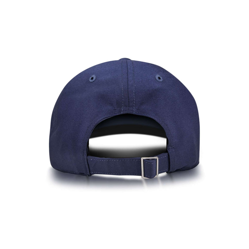 The Reebok Badge Cap is shown from the back in navy blue, with an adjustable strap and metal buckle, plus two ventilation eyelets on each side near the top. The background is plain white.