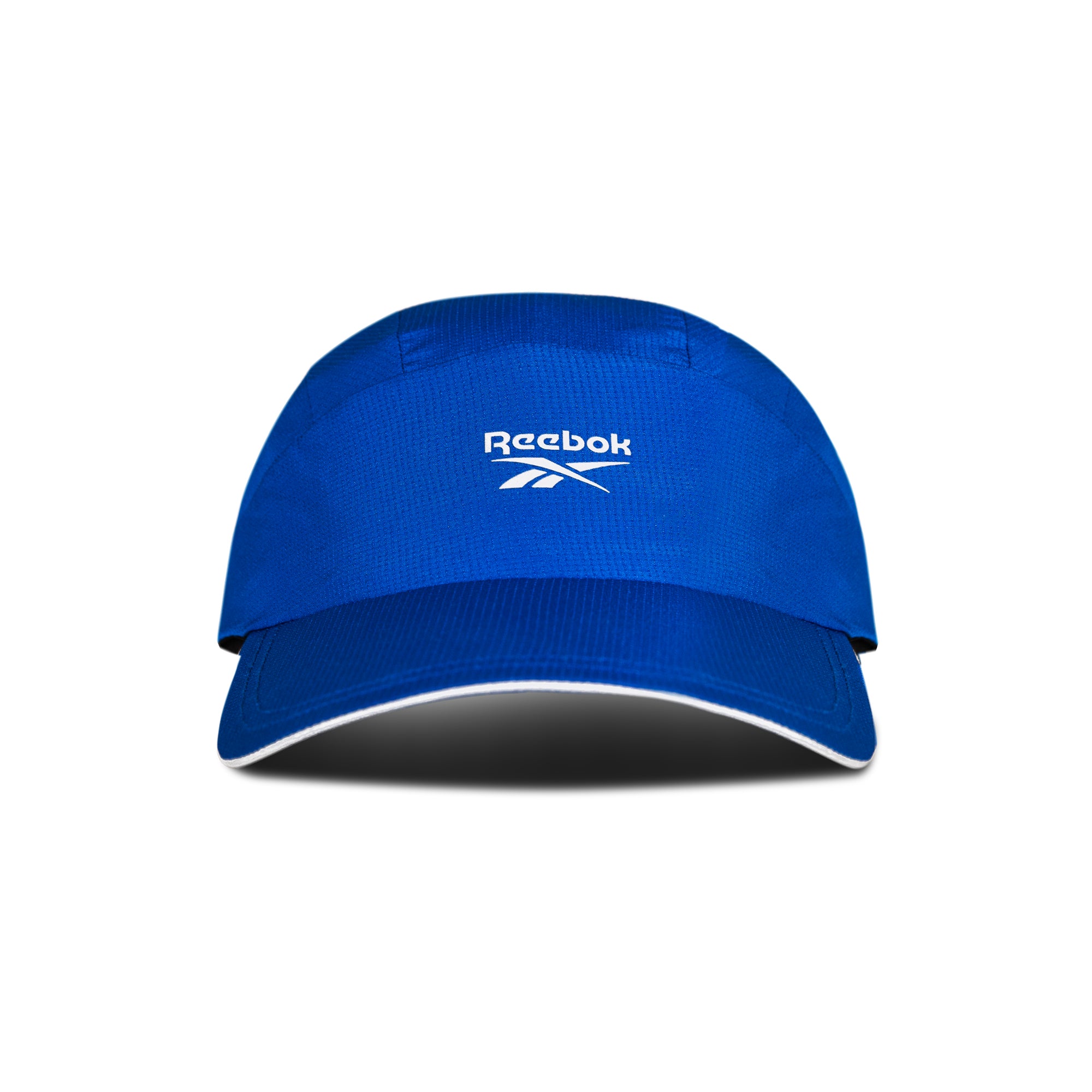 The Reebok Running Cap is a blue sports visor with a curved brim and white Reebok logo on the front, shown on a white background with a shadow. This lightweight cap offers comfort and moisture-wicking performance for runners.