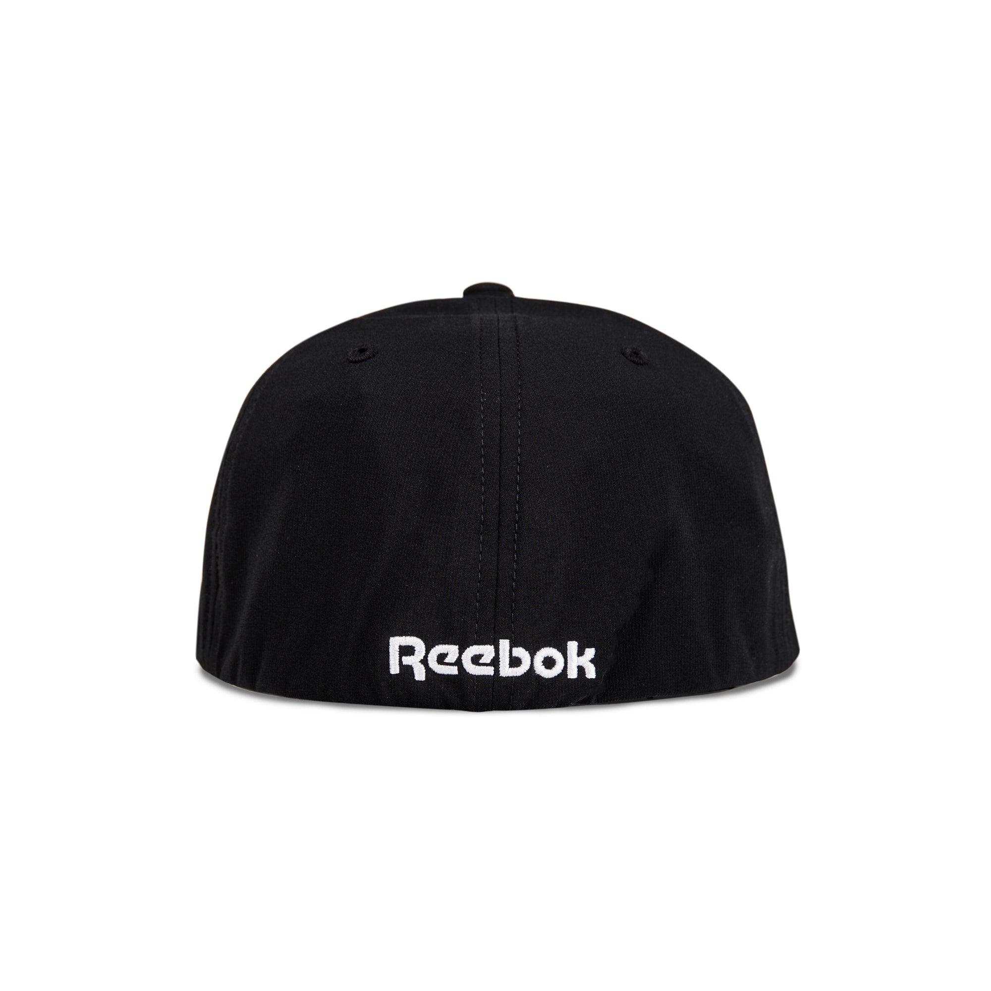 The image shows the back view of the Reebok Range Cap, a black cap featuring the white embroidered Reebok logo near the bottom edge.