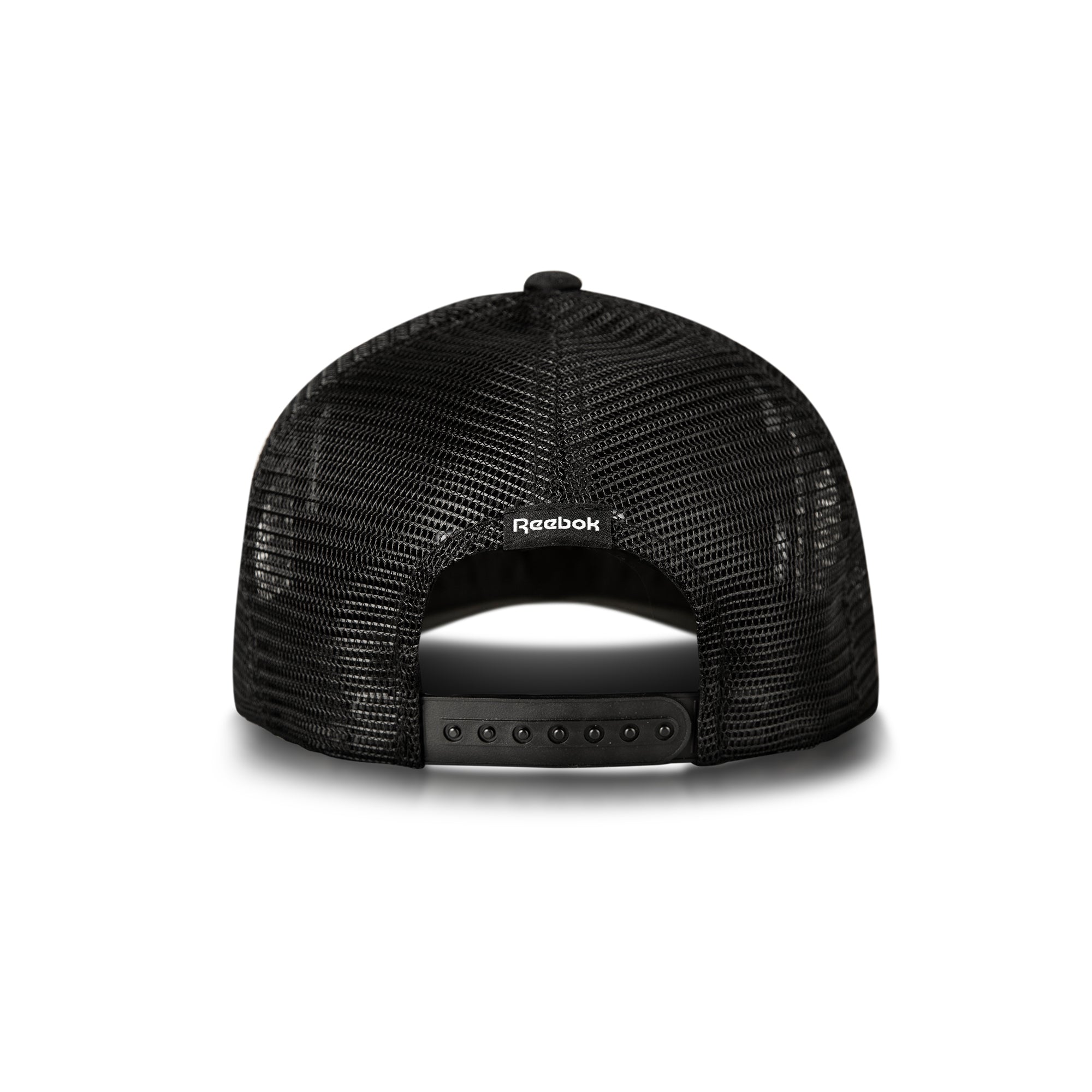Back view of the Reebok Deluxe Aero Cap, shown on a white background, with black mesh, adjustable snapback closure, moisture-wicking sweatband, and the Reebok logo above the opening.