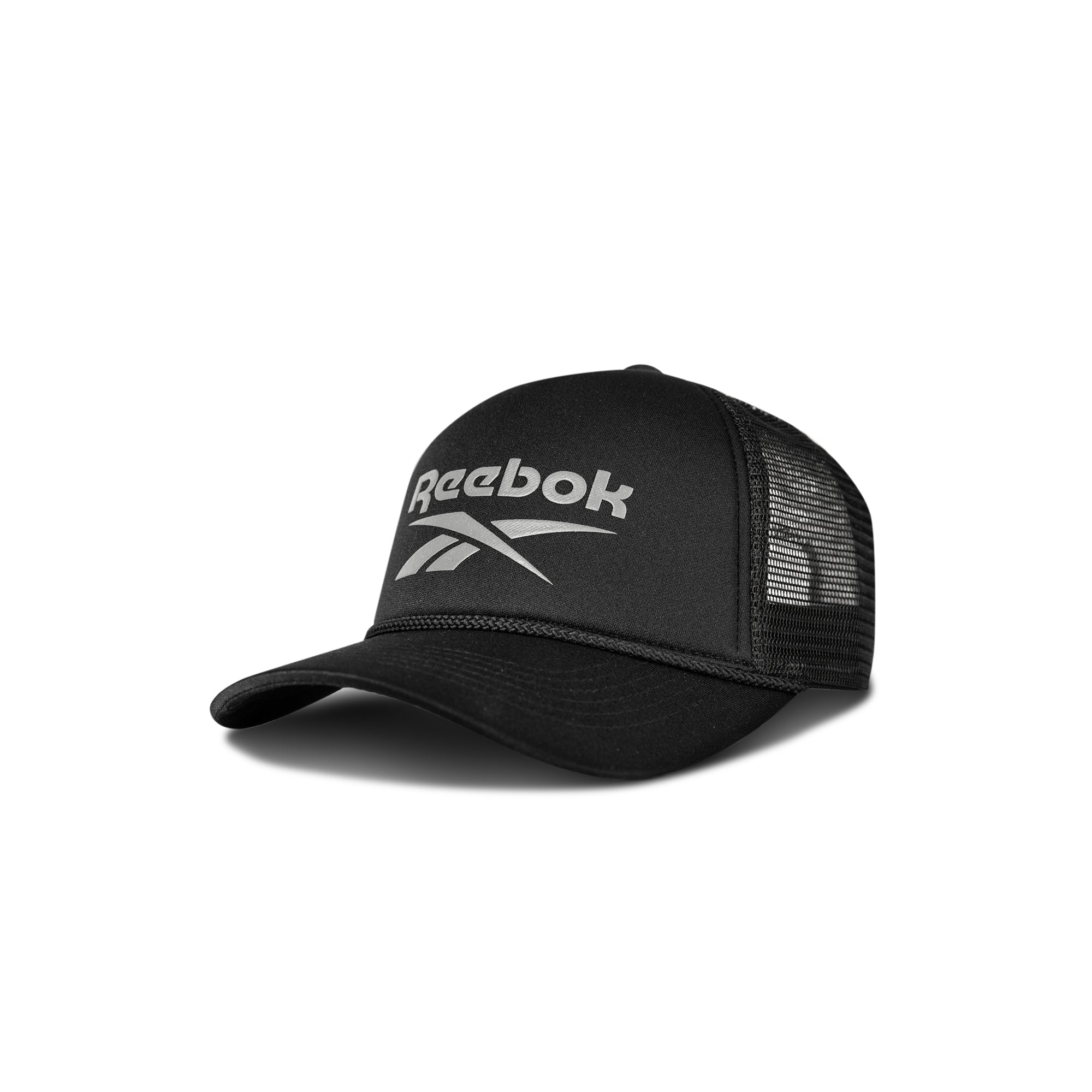 The Reebok Deluxe Aero Cap is a black trucker hat with mesh back panels, curved brim, adjustable snapback closure, and a white Reebok logo on the front. The cap is displayed against a white background.