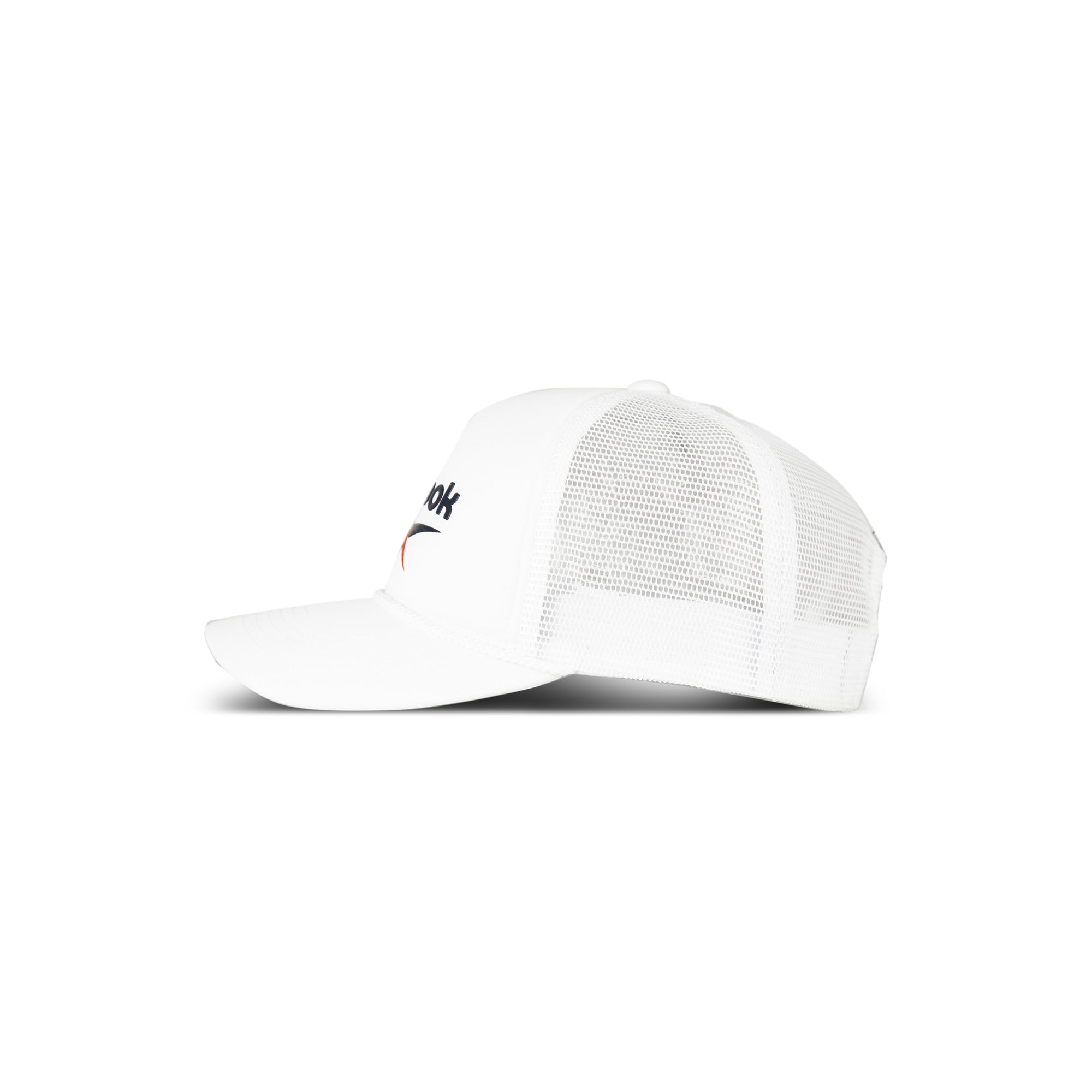 The Reebok Deluxe Aero Cap is a white mesh trucker hat with a curved brim, partial black text, a small swoosh design, and a moisture-wicking sweatband—shown in side profile on a plain white background.