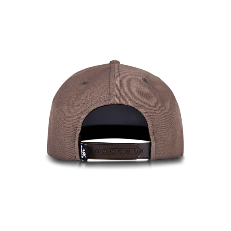 The Reebok Identity Vector Cap is shown from the back against a white background, highlighting its brown color and adjustable black plastic snap button strap.