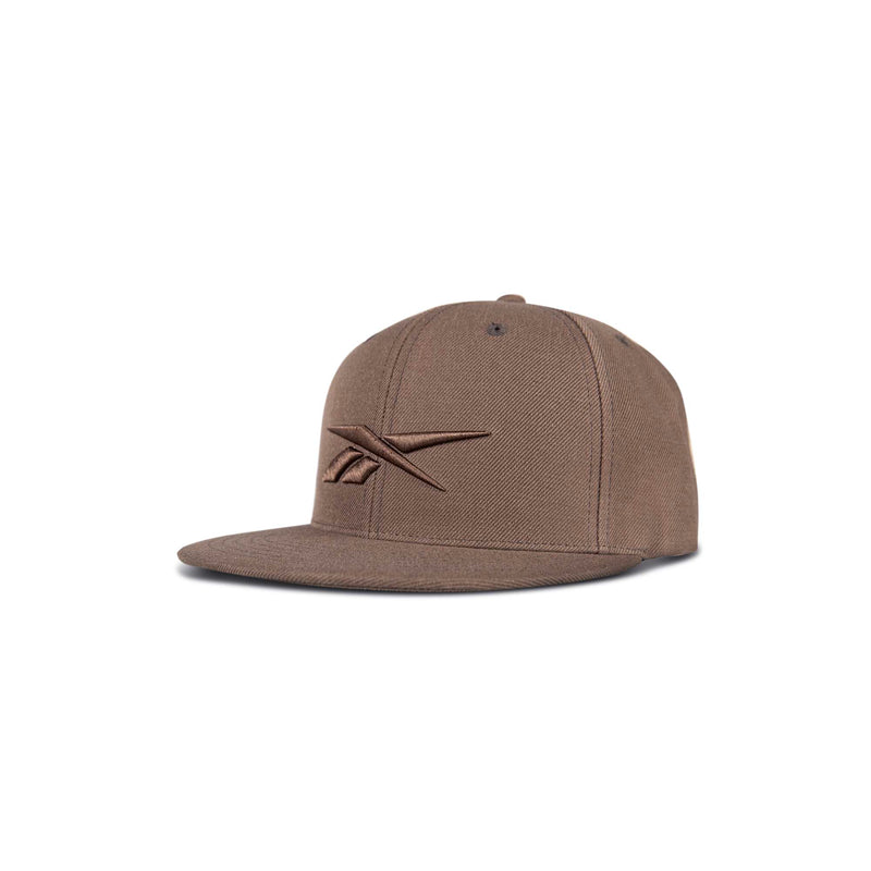 A brown Reebok Identity Vector Cap with a flat brim and embroidered logo on the front, shown against a white background.