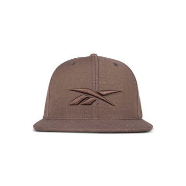 The Reebok Identity Vector Cap is a brown flat-brimmed hat with an embroidered Reebok logo on the front, displayed against a white background.