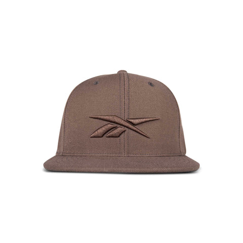 The Reebok Identity Vector Cap is a brown flat-brimmed hat with an embroidered Reebok logo on the front, displayed against a white background.