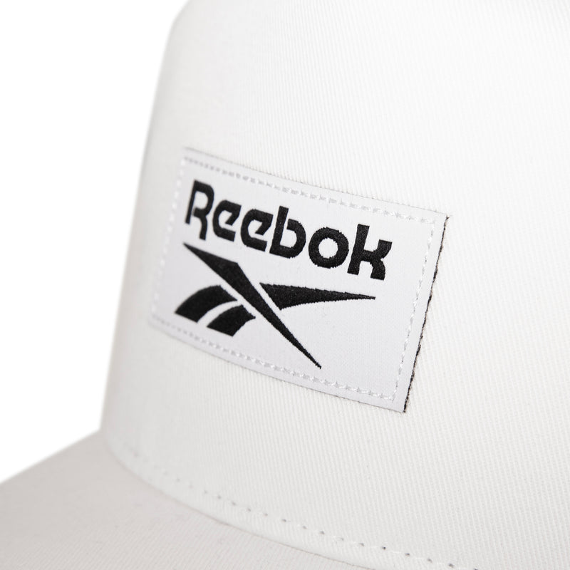 Close-up of the Reebok Classic 5 Cap featuring a stitched rectangular patch with the black Reebok logo and name on the front, designed in a modern 5-panel silhouette.