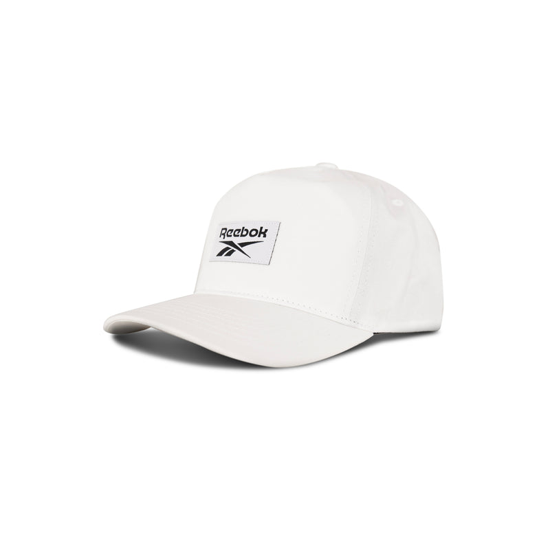 The Reebok Classic 5 Cap is a white hat with a 5-panel design, curved brim, and black logo patch. Displayed against a plain white background.