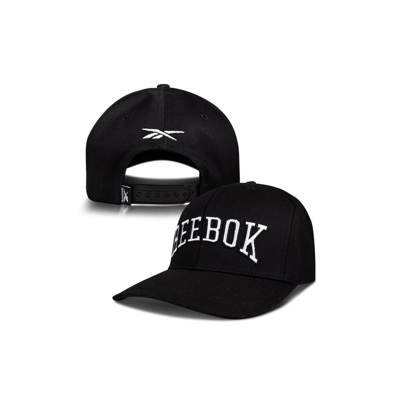Two black Reebok Gameday Caps: one displays "REEBOK" in large white letters on the front, the other shows the back with an adjustable strap and embroidered Reebok logo. A vintage-inspired baseball cap for classic style.