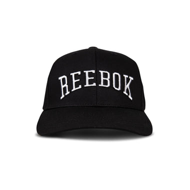 The Reebok Gameday Cap is a vintage-inspired black baseball cap with large white REEBOK embroidery across the front, shown on a plain white background.