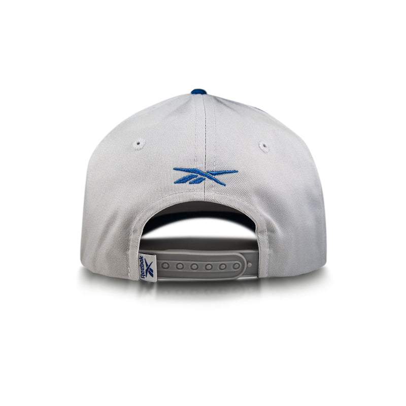 A gray Reebok Gameday Cap shown from the back, featuring a vintage-inspired design, adjustable strap, and blue embroidered Reebok logo above the opening.