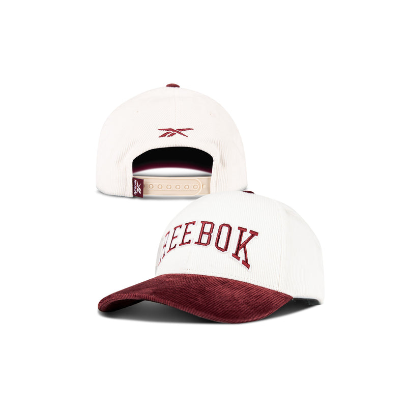 Two white Reebok Corduroy Gameday Caps with burgundy brims, made of cotton corduroy; one features embroidered REEBOK on the front, the other has an adjustable snap closure and a small Reebok logo on the back.
