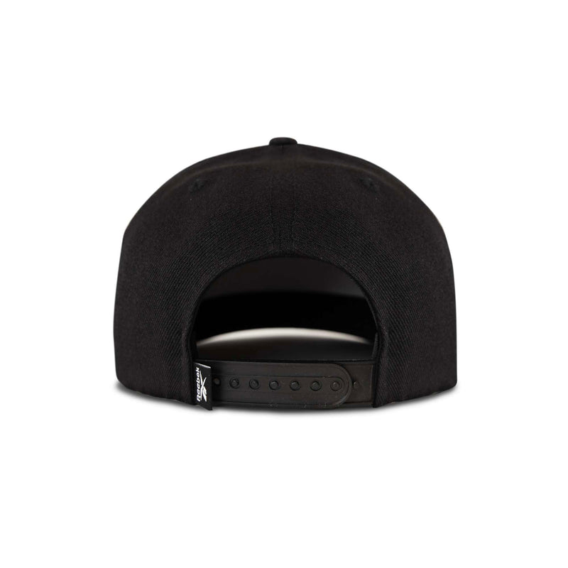 The Reebok Pump Hat by Reebok is a black snapback cap shown from the back, featuring an adjustable strap and a small black tag with white text on the left side. The background is plain white.
