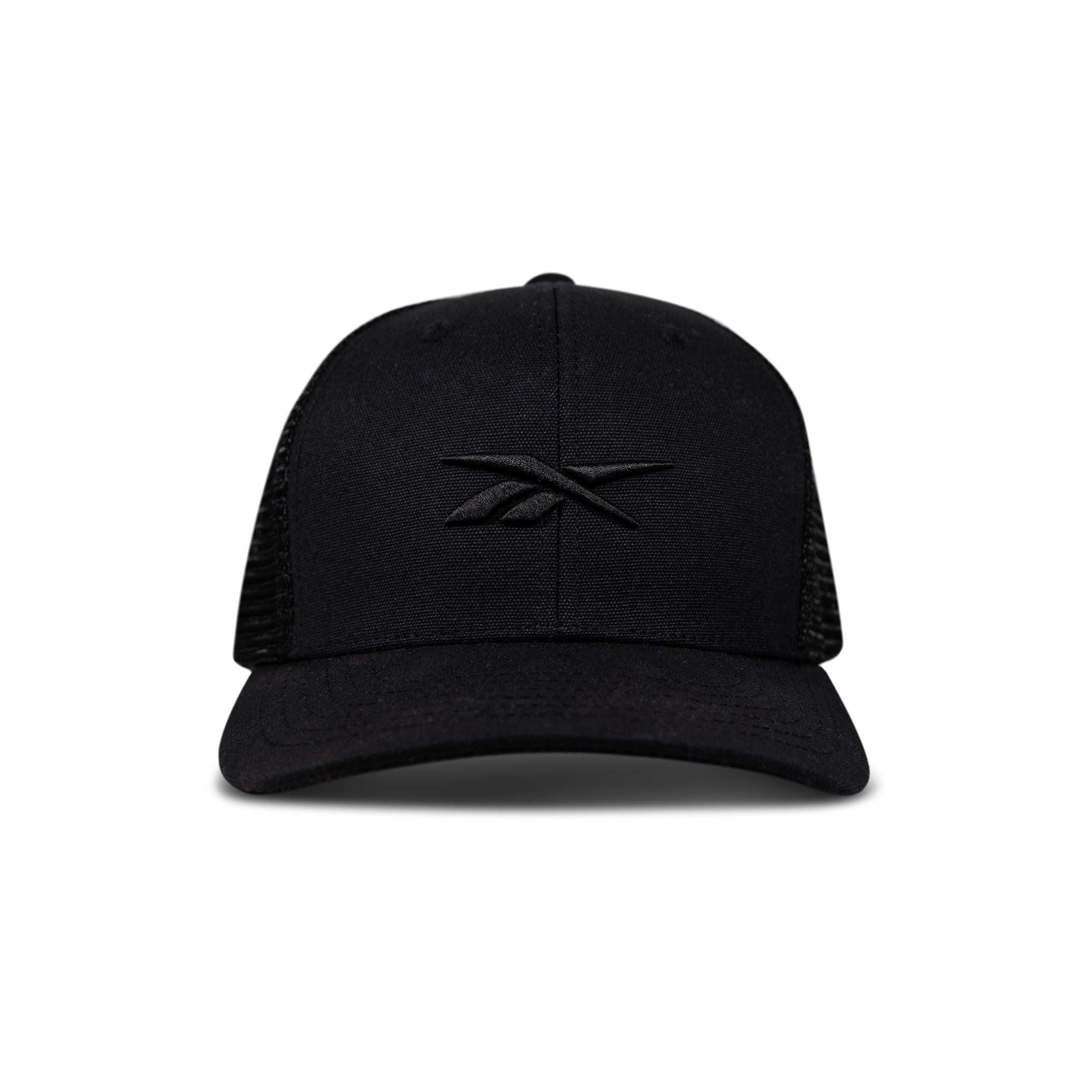 Front view of the Reebok Embroidered Vector Trucker Cap in black, featuring a curved brim, mesh back, and embroidered black Reebok logo on the front panel. Shown against a plain white background.